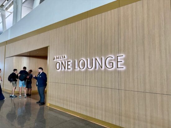 a group of people standing in front of Delta One Lounge New York