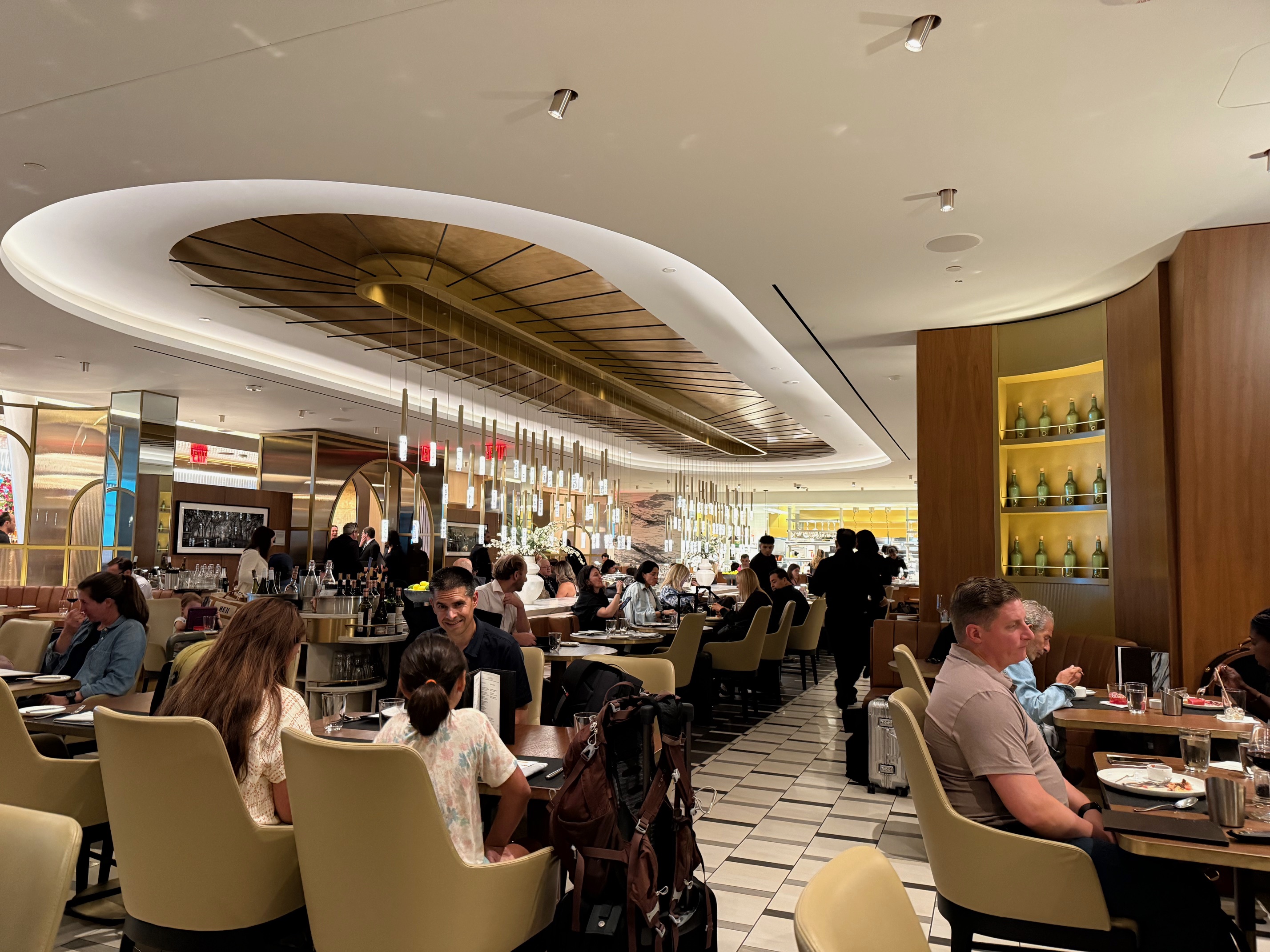 a group of people sitting at tables in the Delta One Lounge New York