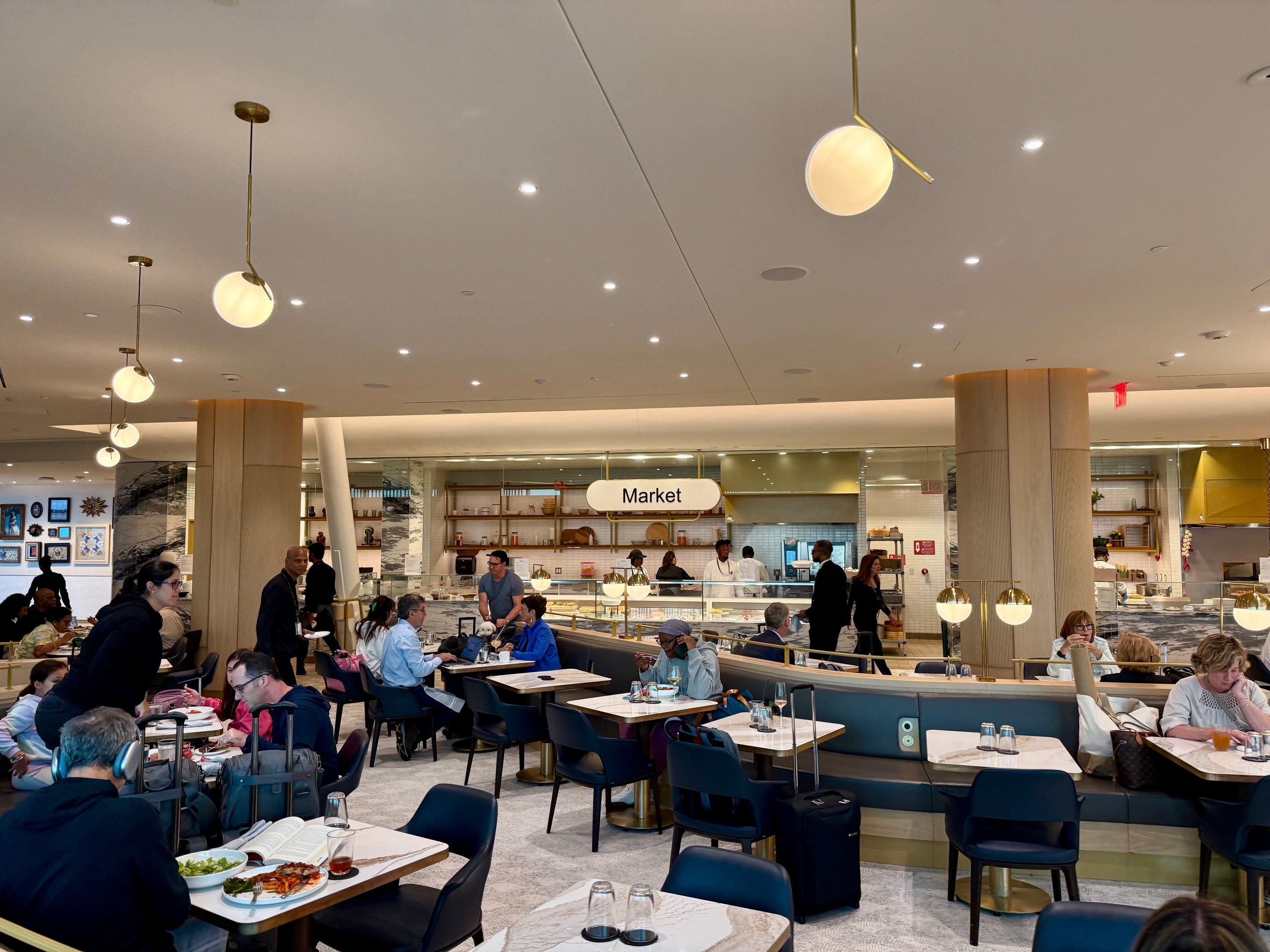 a group of people sitting at tables in a restaurant