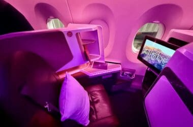 a seat and monitor in a plane on a Virgin Atlantic A350 Upper Class Cabin