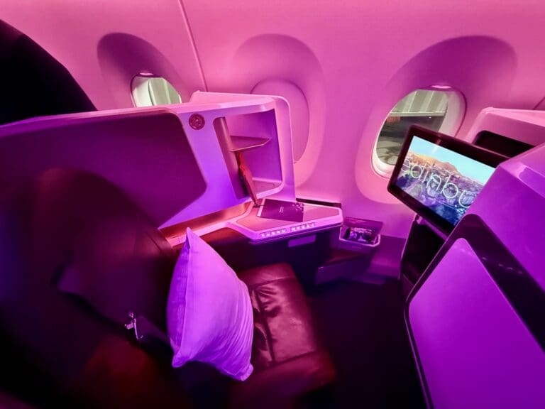 a seat and monitor in a plane on a Virgin Atlantic A350 Upper Class Cabin