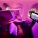 a seat and monitor in a plane on a Virgin Atlantic A350 Upper Class Cabin