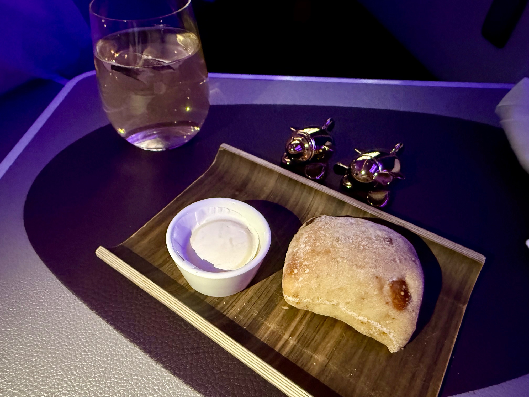 a tray with food and a glass of water on it