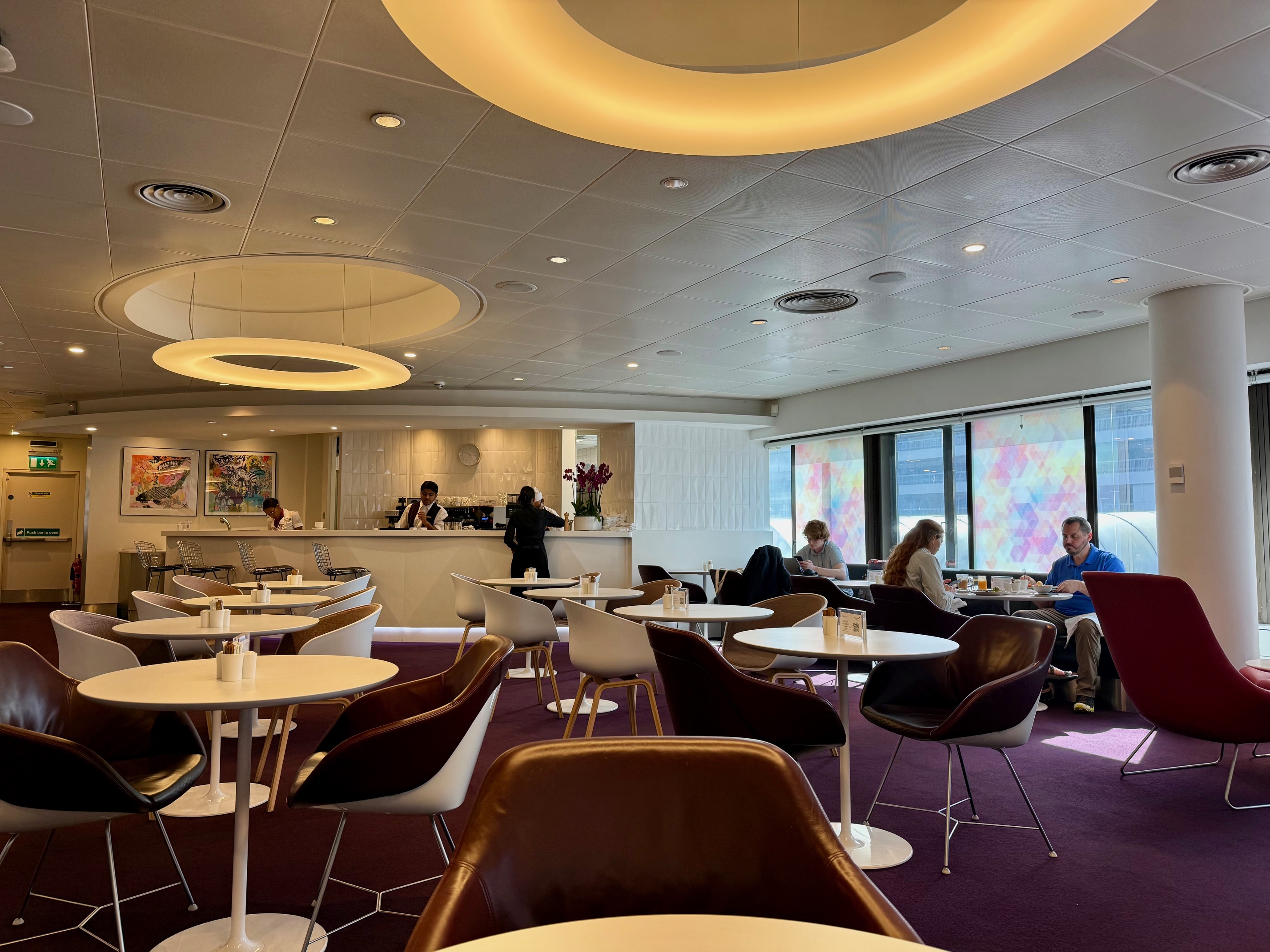 a room with tables and chairs at the Virgin Atlantic Revivals Lounge