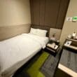 a small hotel room with a bed and a small table at the Aerotel London