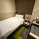 a small hotel room with a bed and a small table at the Aerotel London