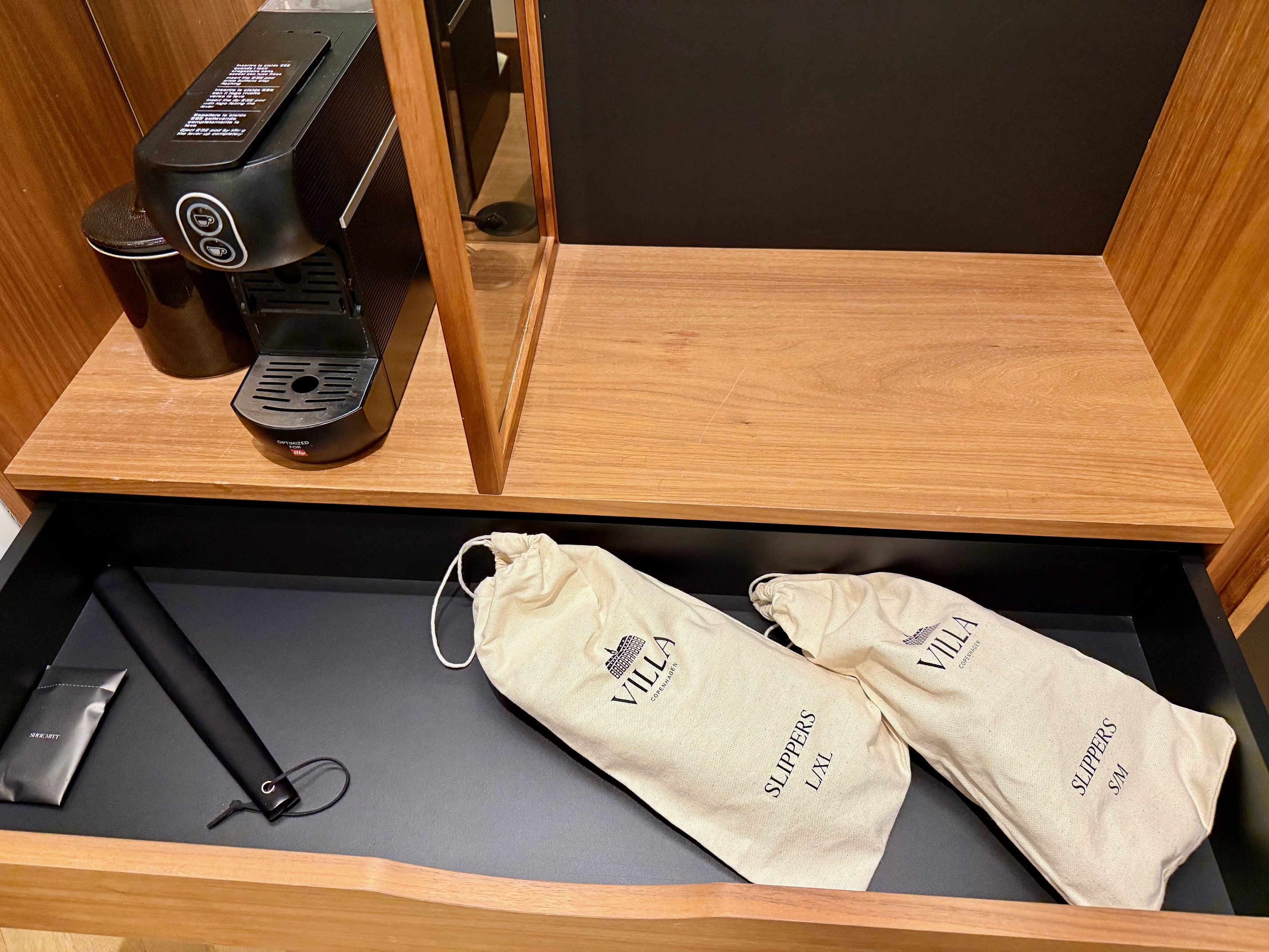 a coffee machine and bags on a shelf