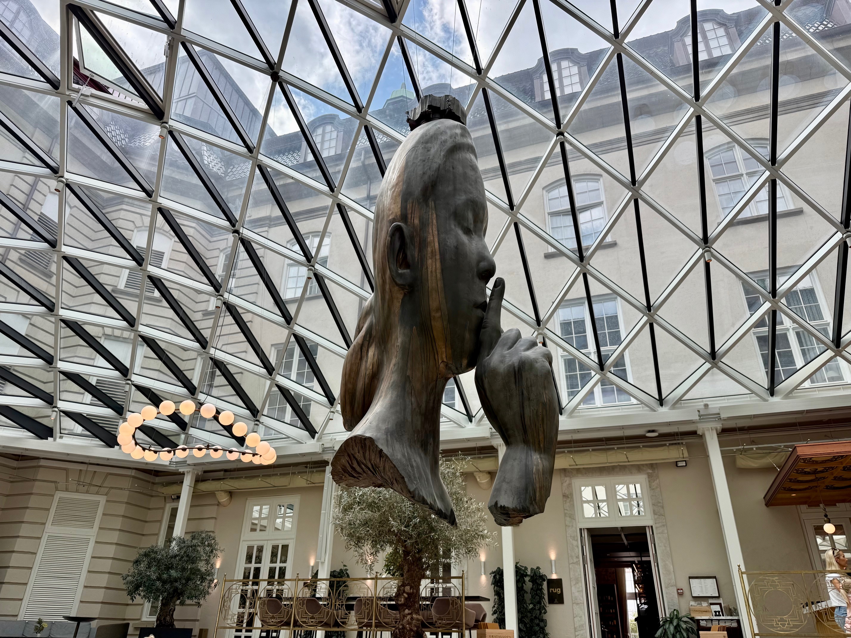 a statue of a woman's head in a glass ceiling