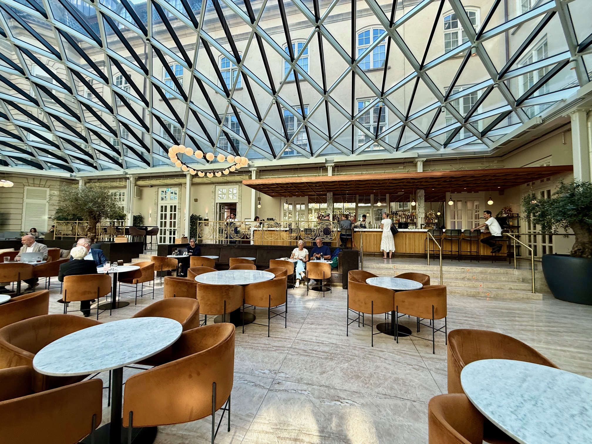 a large glass ceiling with tables and chairs