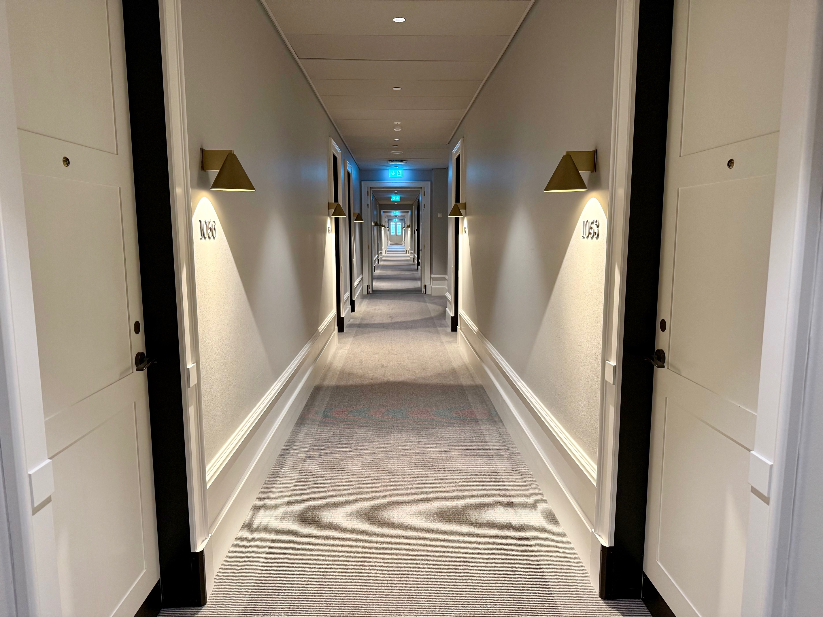 a hallway with lights on the wall