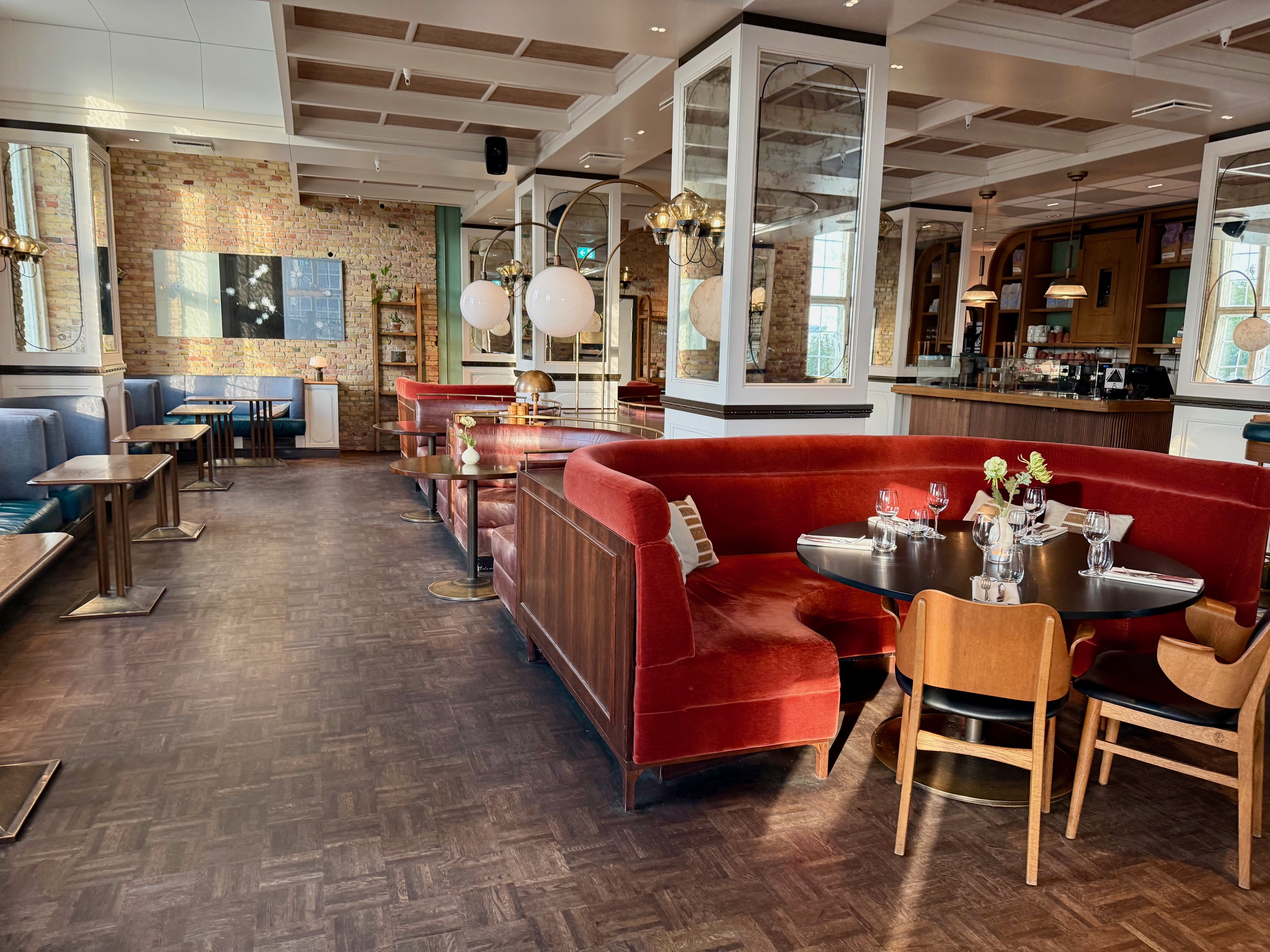 a restaurant with red couches and tables