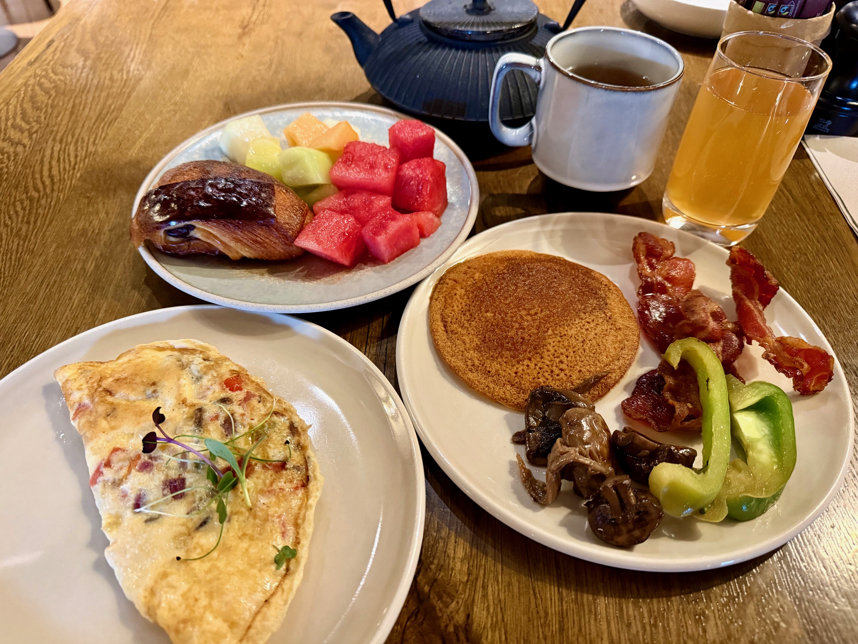 a plate of food and a teapot on a table