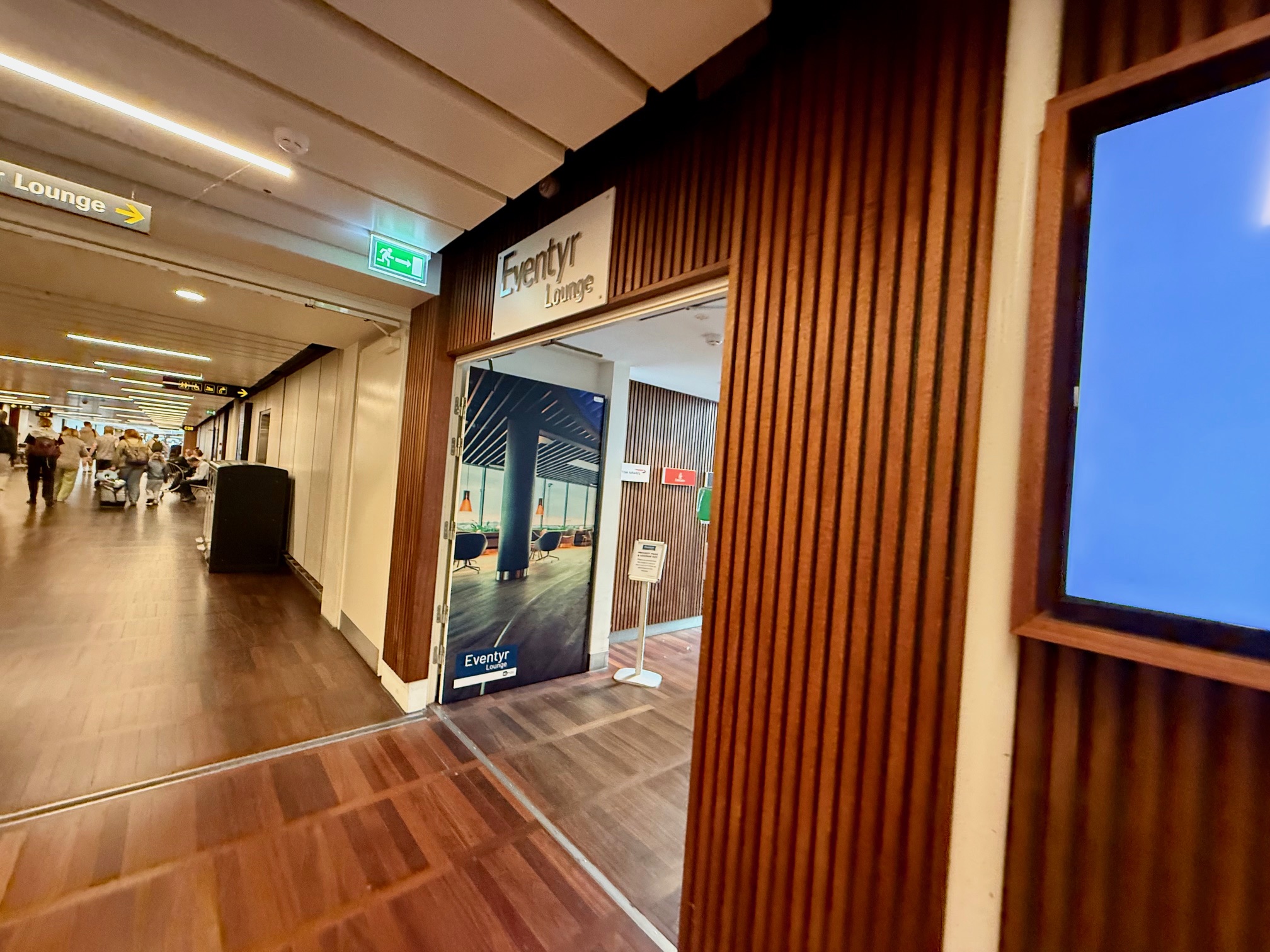 a hallway with a sign and a screen