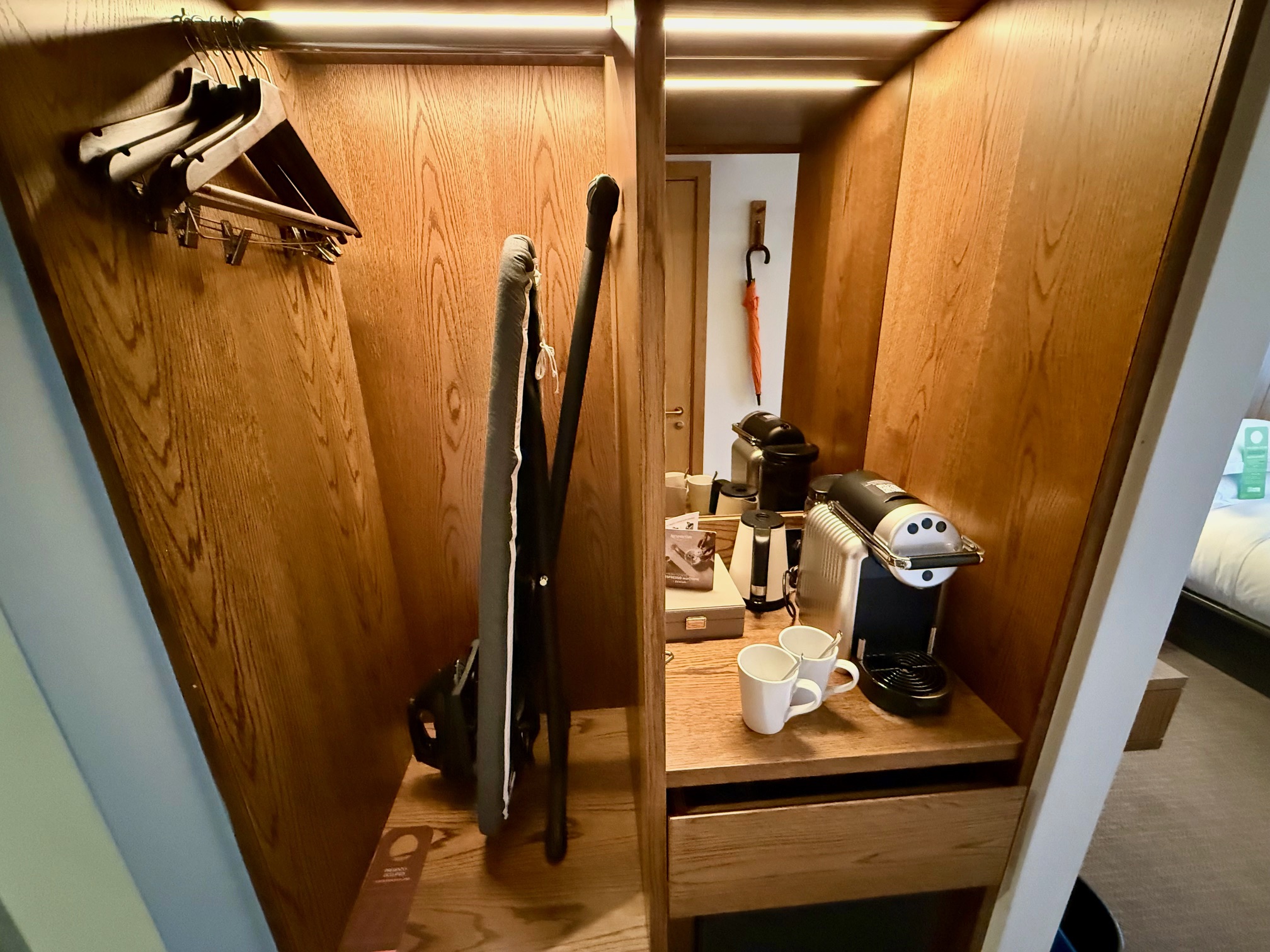 a closet with a coffee machine and a cup