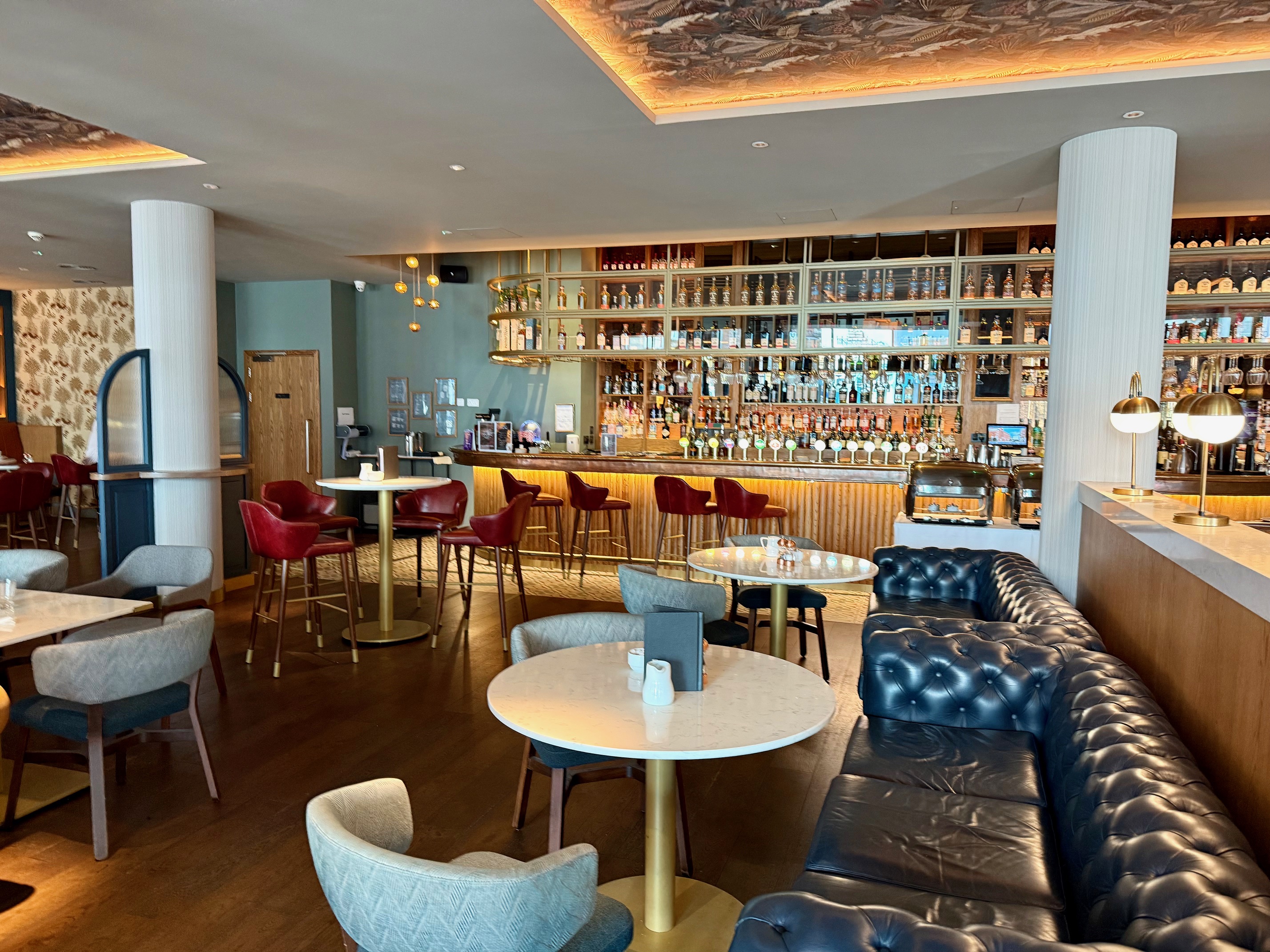 a room with tables and chairs at the Hyatt Centric The Liberties Dublin