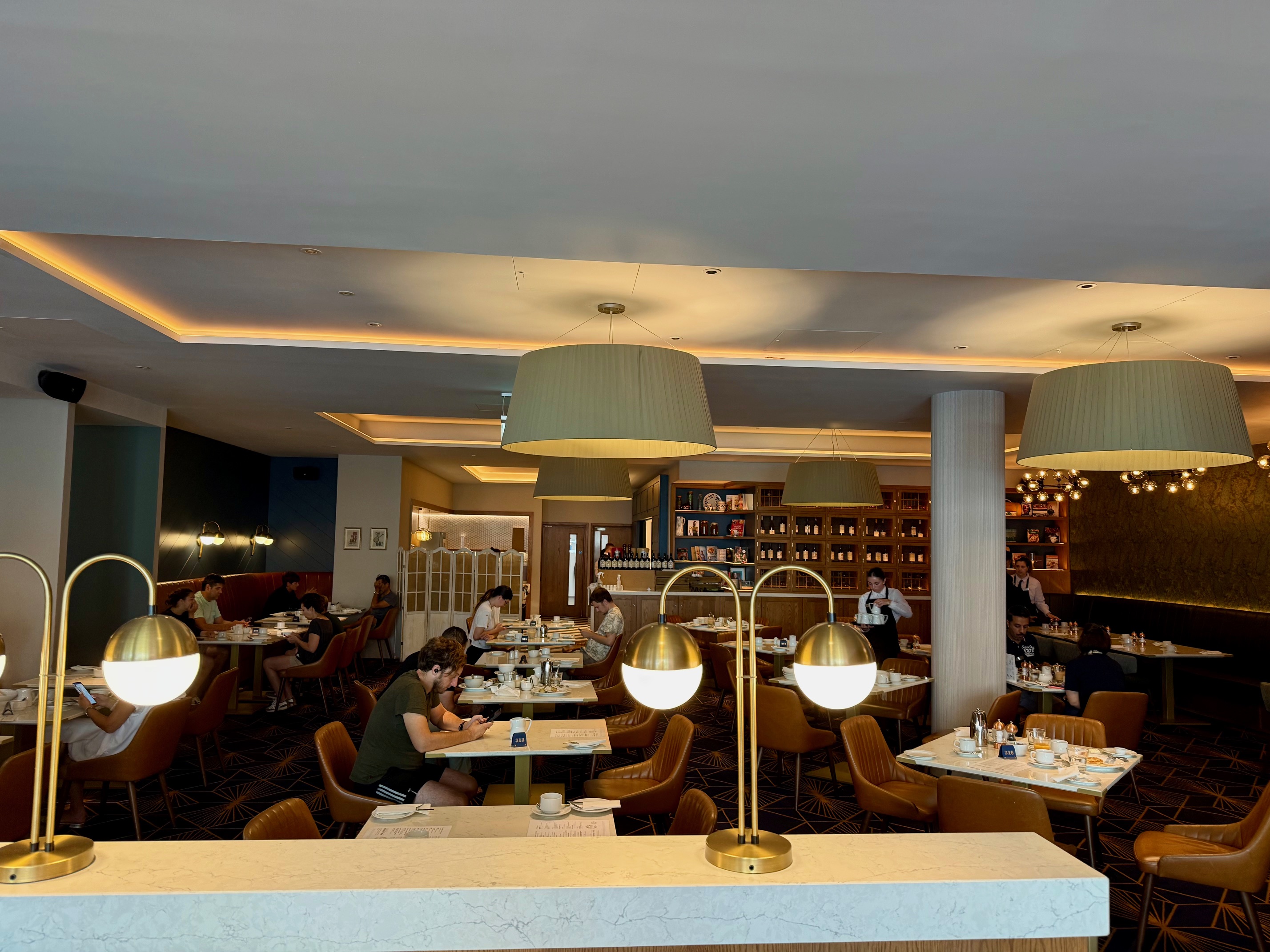 a group of people sitting at tables in a restaurant