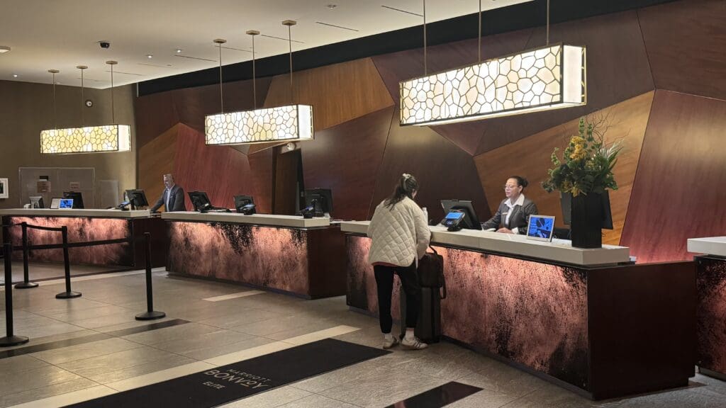 people at a hotel reception desk
