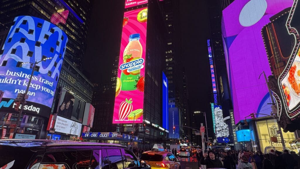 a city street with tall buildings and billboards