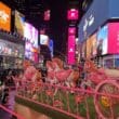 a pink horse carousel in a city