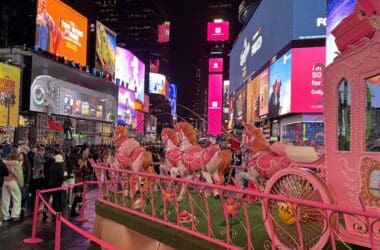 a pink horse carousel in a city