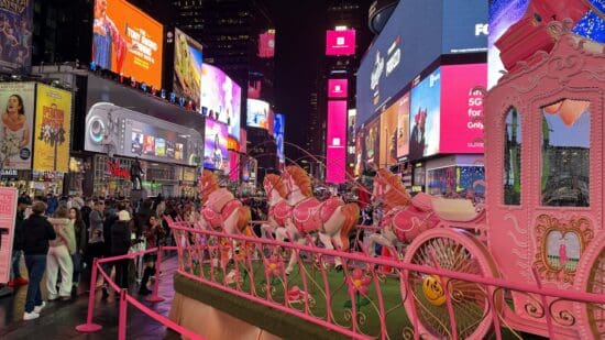 a pink horse carousel in a city