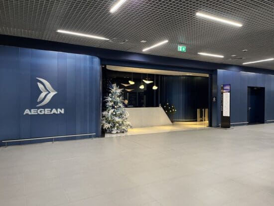 a large blue building with a christmas tree