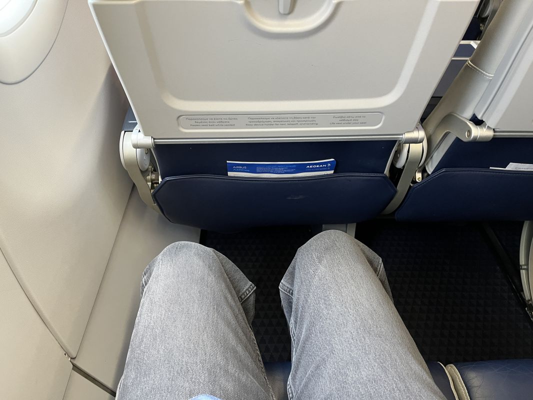 a person's legs in a plane