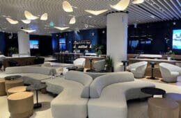 a large room with white couches and tables