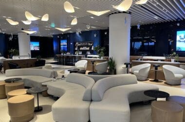 a large room with white couches and tables