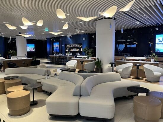 a large room with white couches and tables