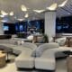 a large room with white couches and tables