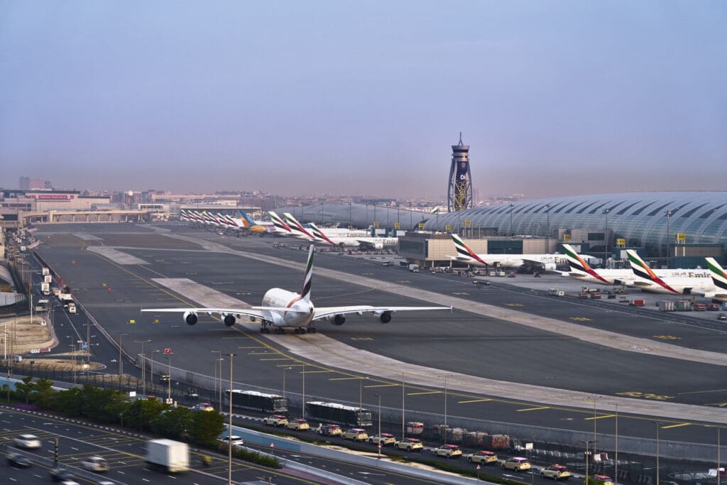An Emirates Airbus A380 taxis past a terminal at Dubai International Airport