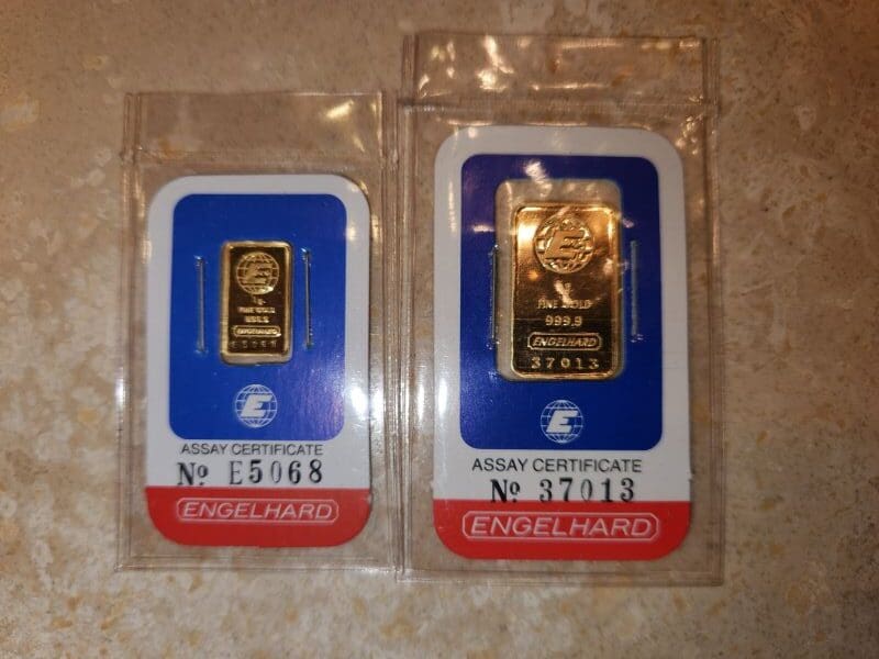 two gold bars in plastic packaging