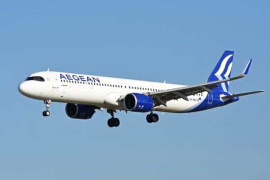 a white and blue airplane flying in the sky