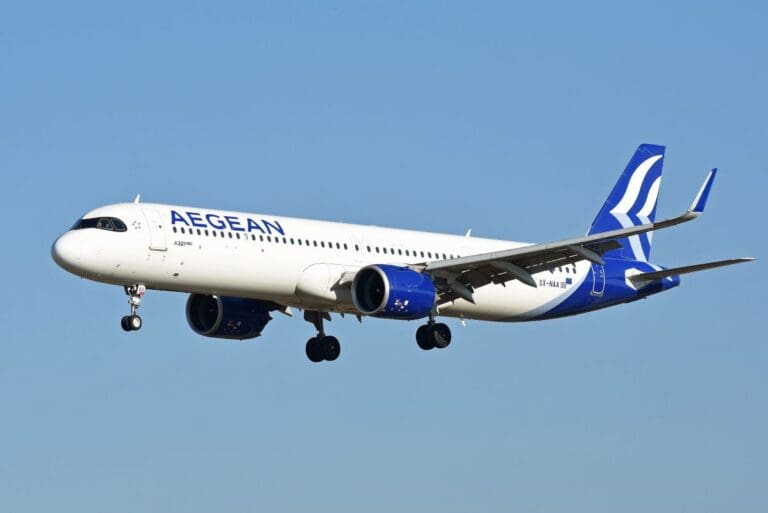 a white and blue airplane flying in the sky