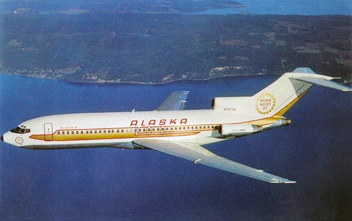 a white airplane flying over water