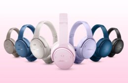 7 sets of Bose QuietComfort headphones in various colors on a pink and white background