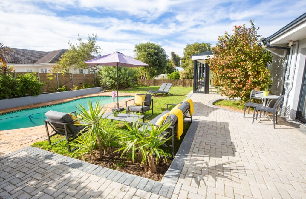 a patio with chairs and a pool