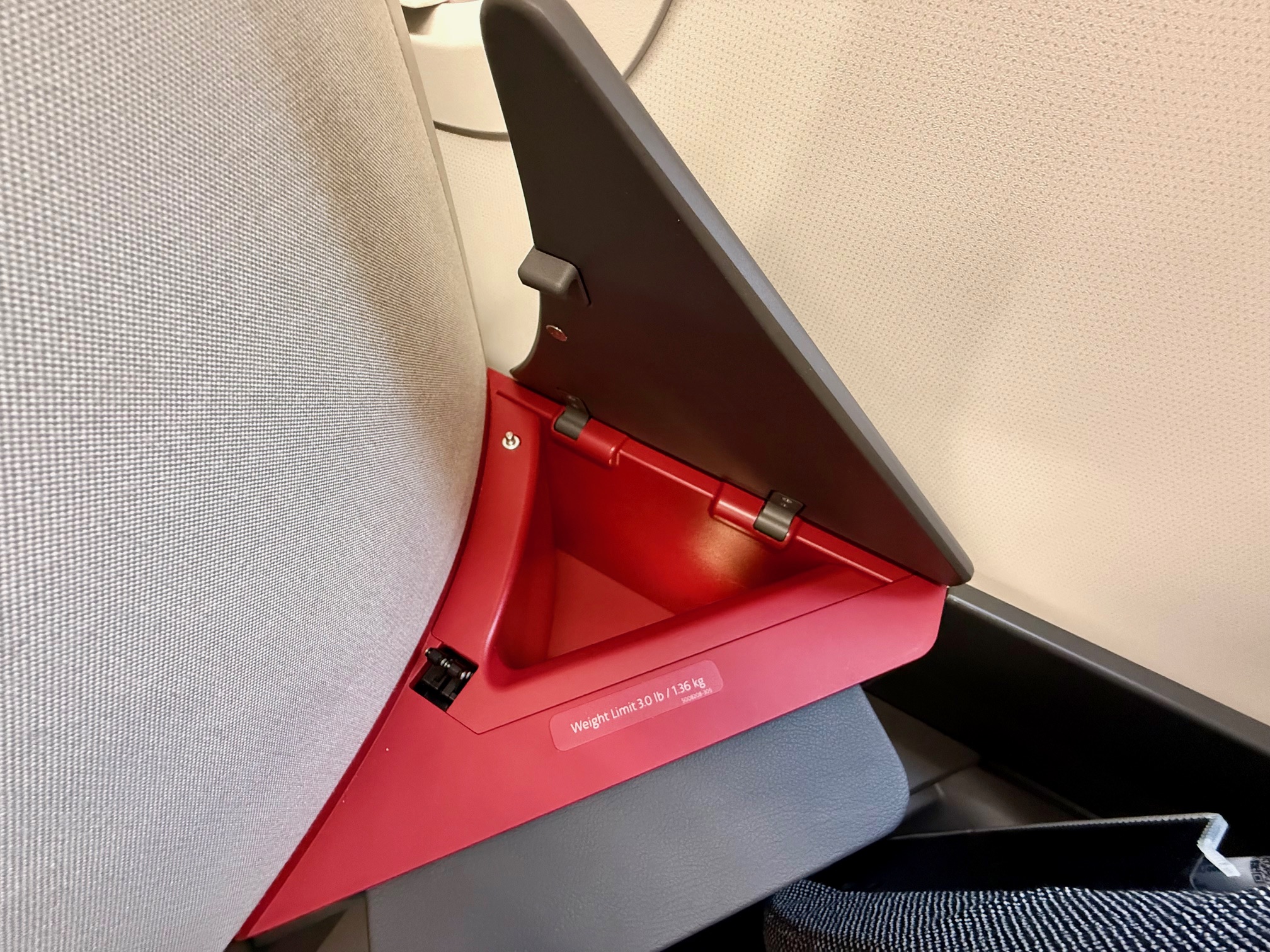 a red and grey object on a seat