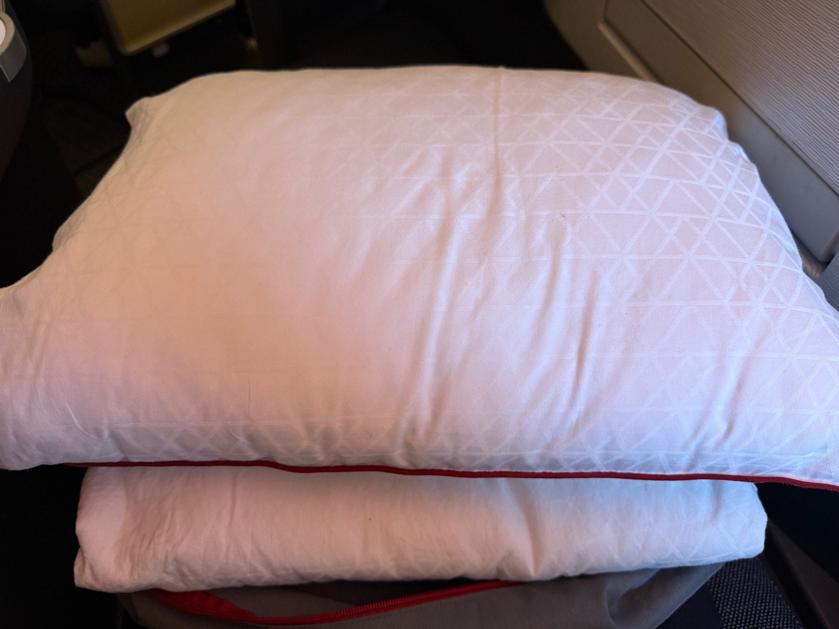 a stack of pillows on a chair