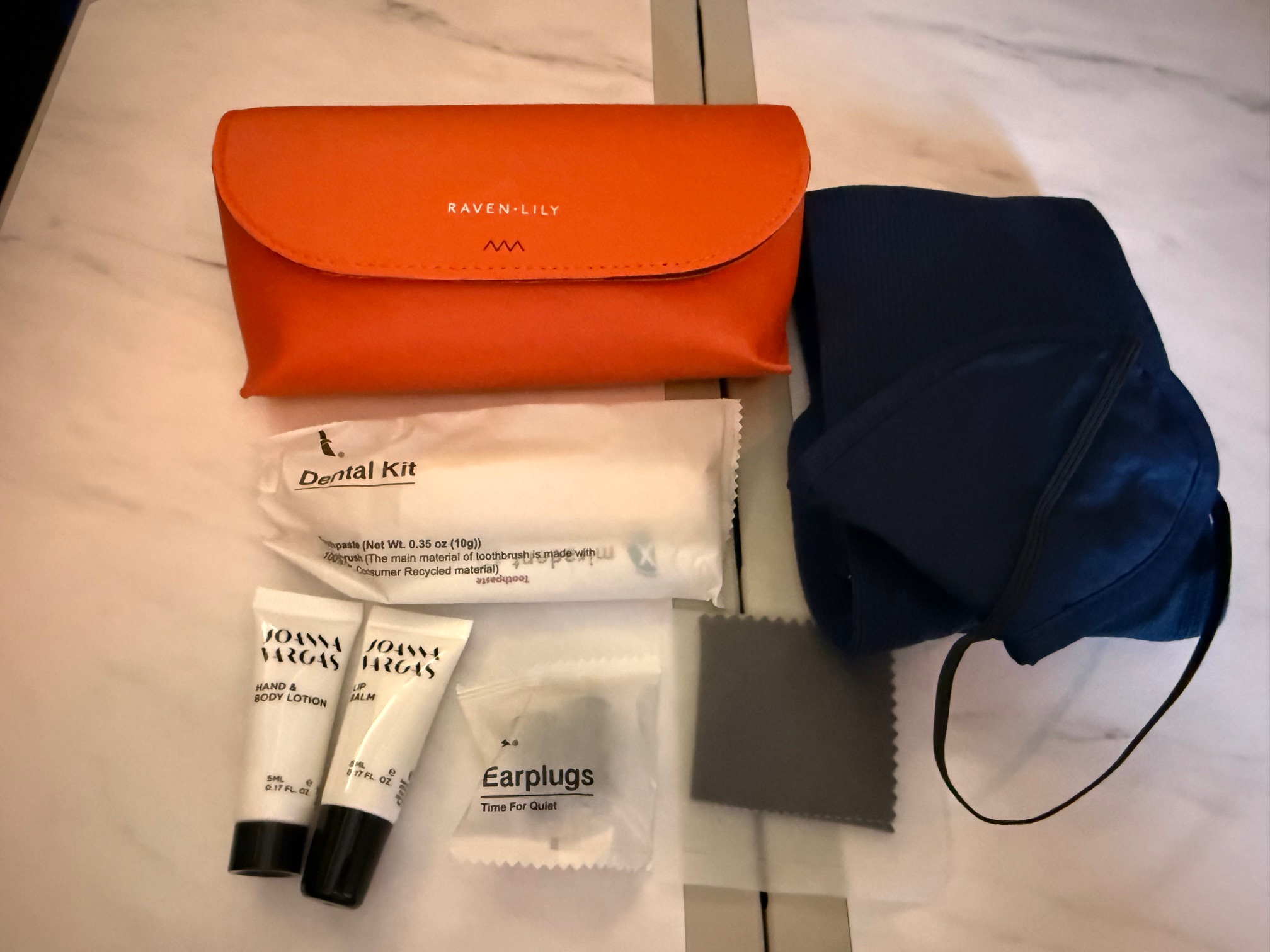 a small orange bag and other items on a table