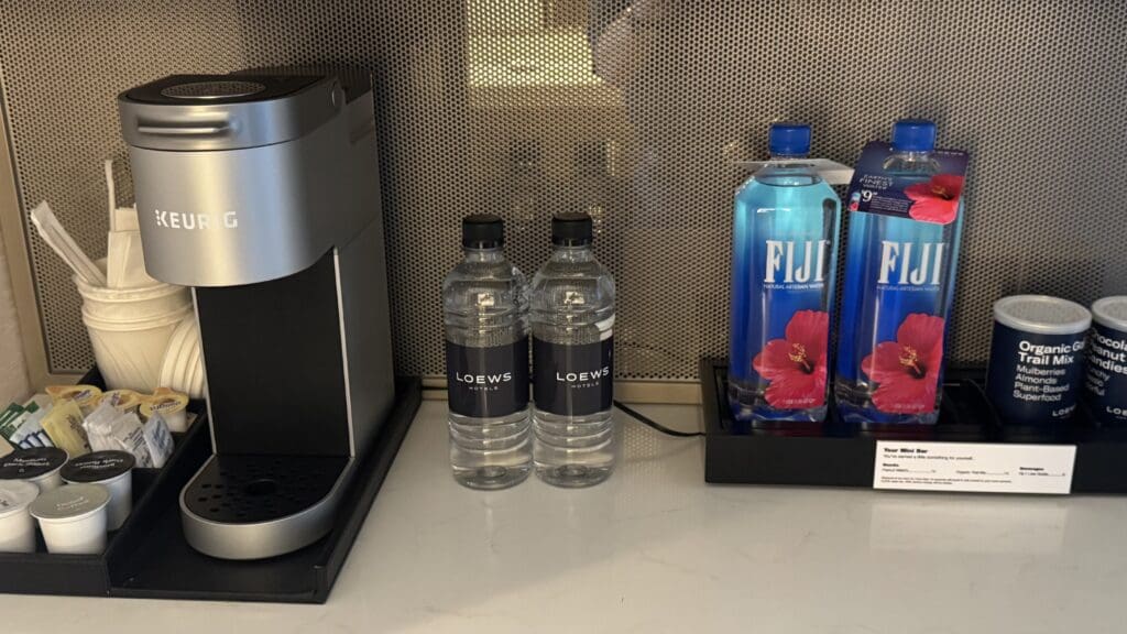 two bottles of water next to a coffee machine