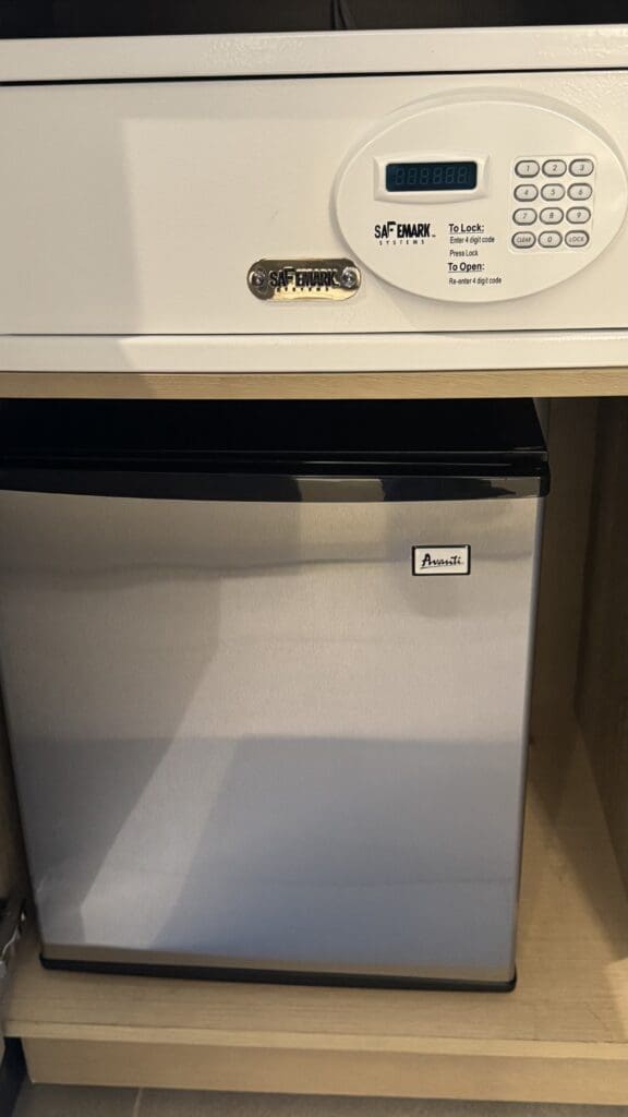 a small white dishwasher under a white cabinet