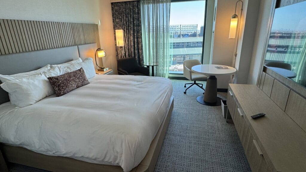 a hotel room with a bed and a table and chairs