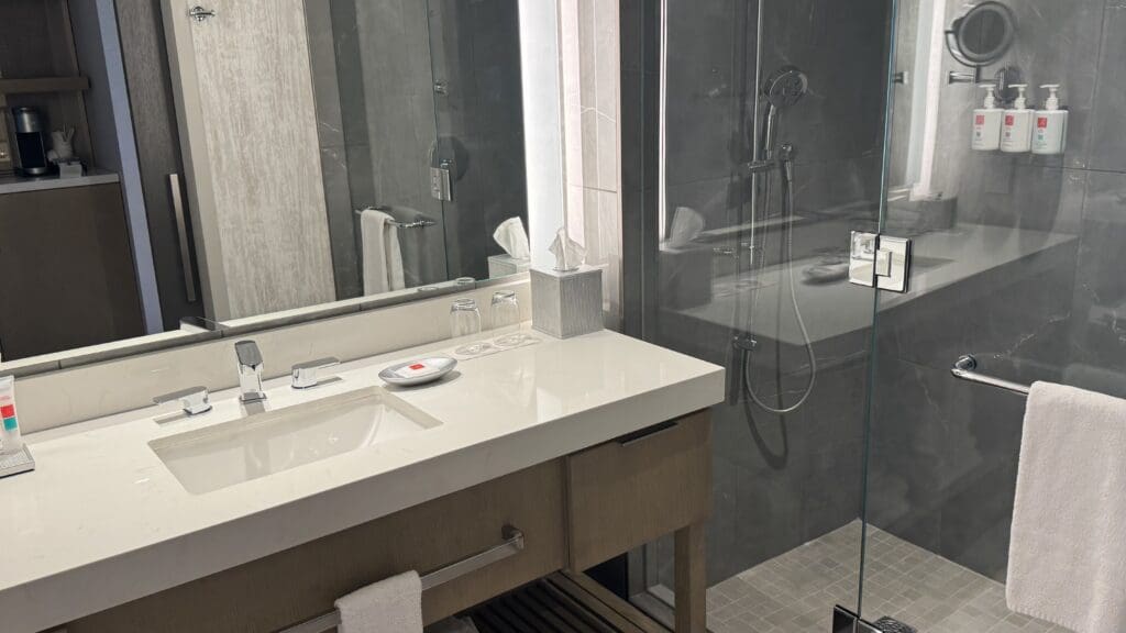 a bathroom with a glass shower and sink