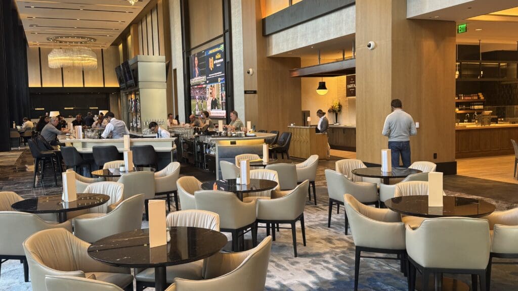 a group of people sitting at tables in a large room