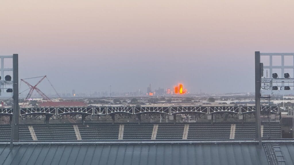 a stadium with a city in the background