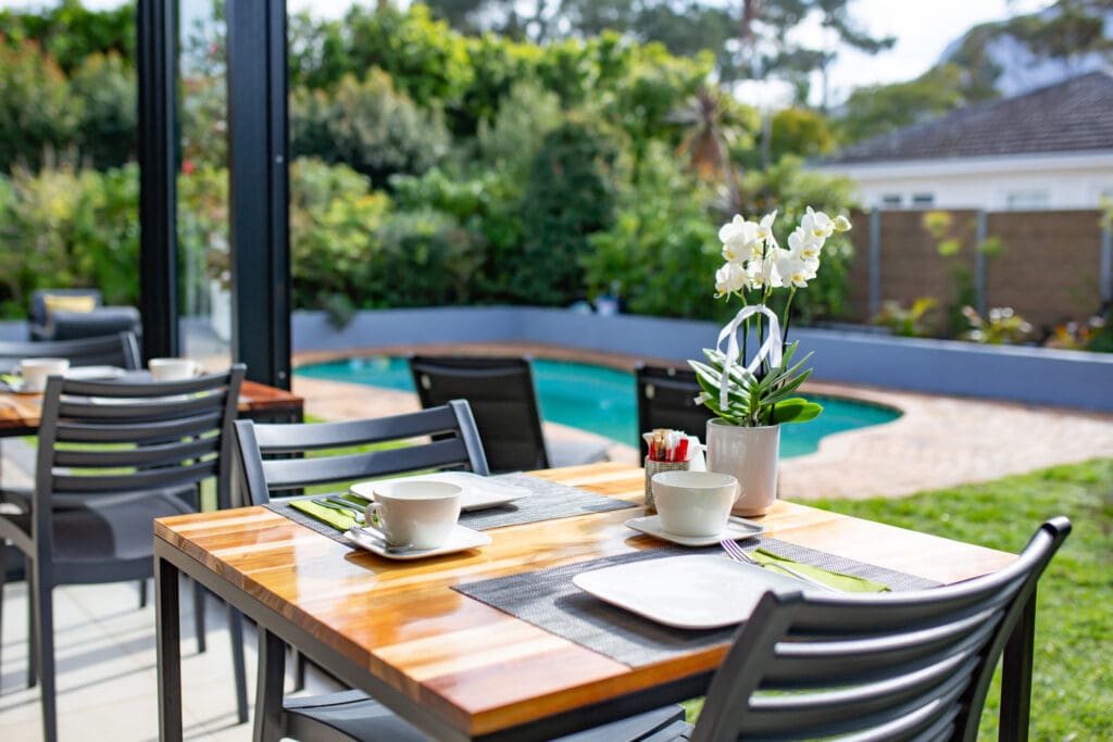 a table set up with a plant and a pot of flowers on it