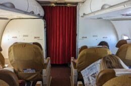 a group of people sitting in chairs on an airplane