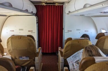 a group of people sitting in chairs on an airplane